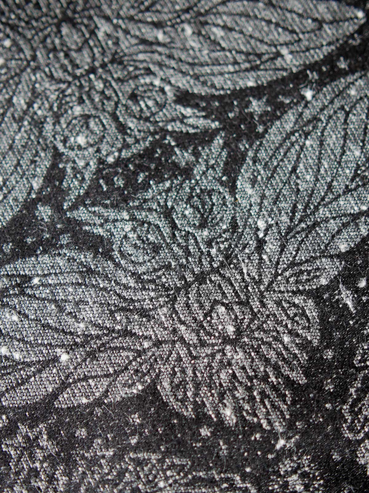 Close up of a silver owl on back backgound.