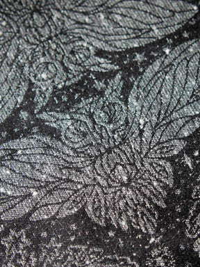 Close up of a silver owl on back backgound.