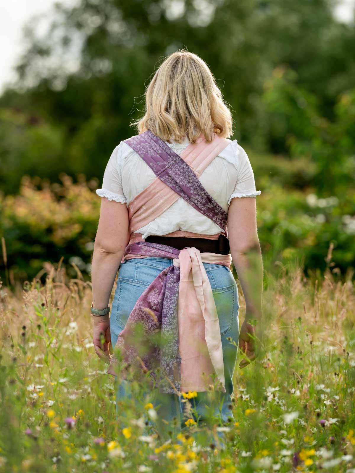 Back view of model in Cairis carrier showing padded straps. 