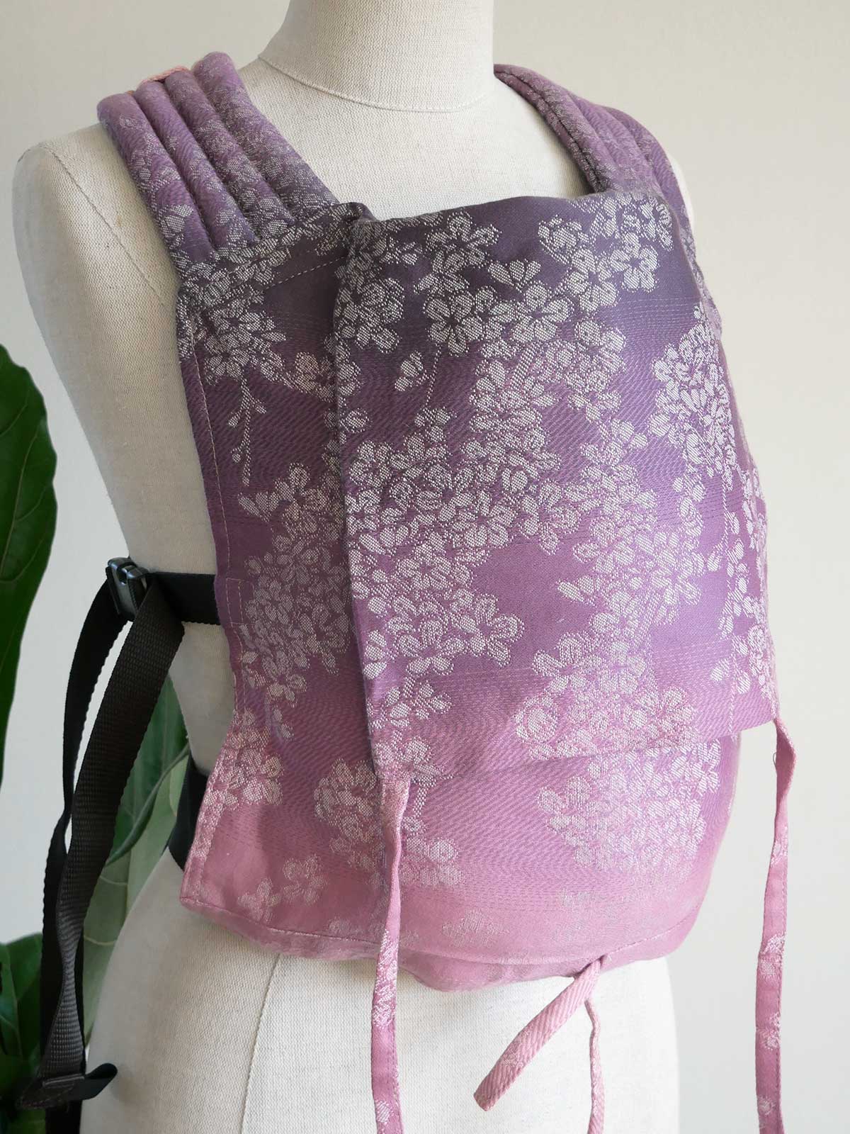 Purple floral-patterned shawl on a mannequin with a white background