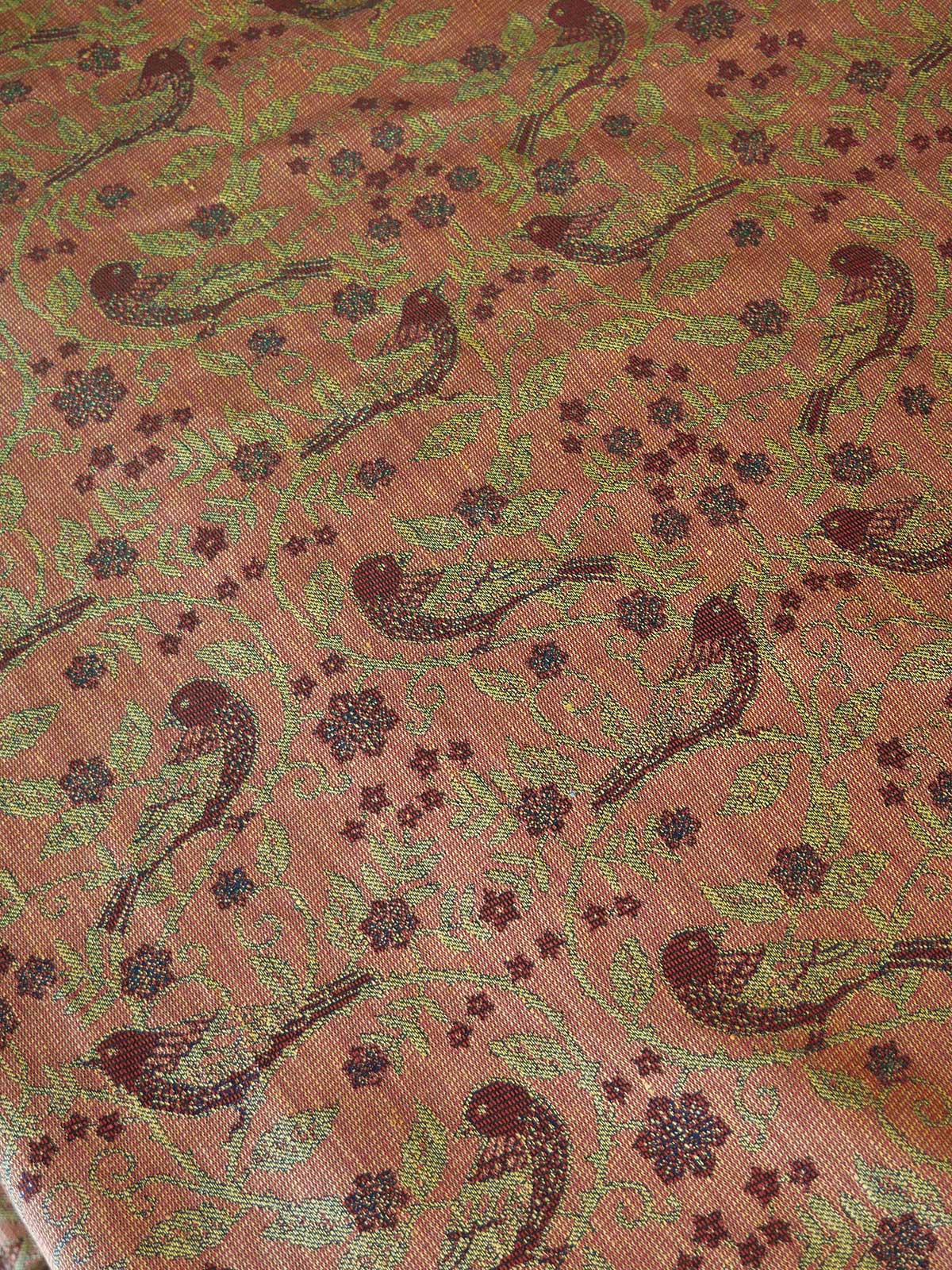 Patterned fabric with birds and floral designs on a red background