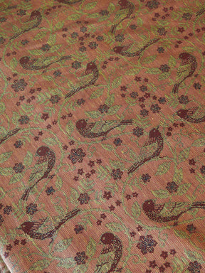 Patterned fabric with birds and floral designs on a red background