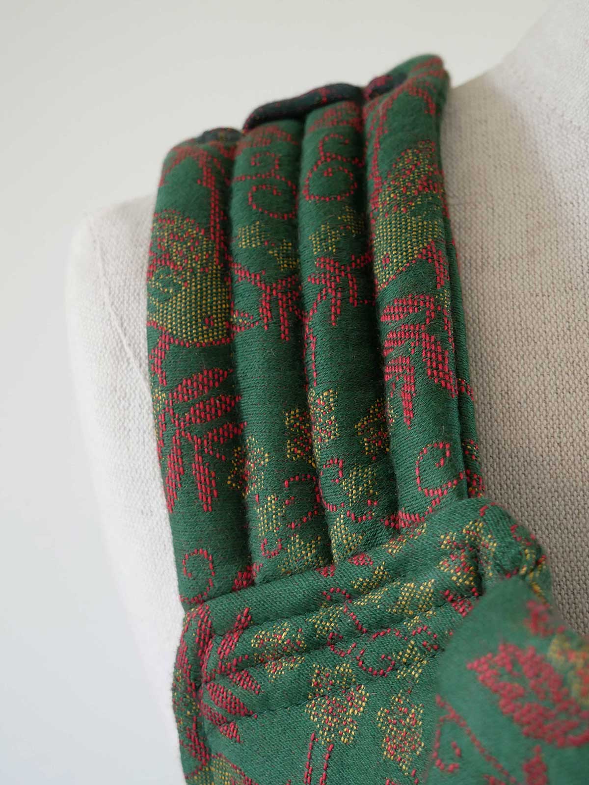 Green and red patterned fabric on a white background