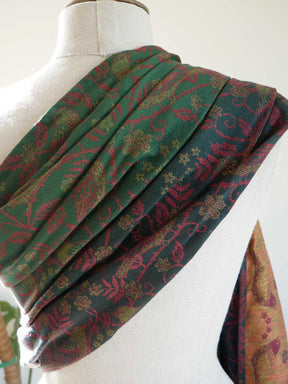 Green and red patterned sling draped over a mannequin