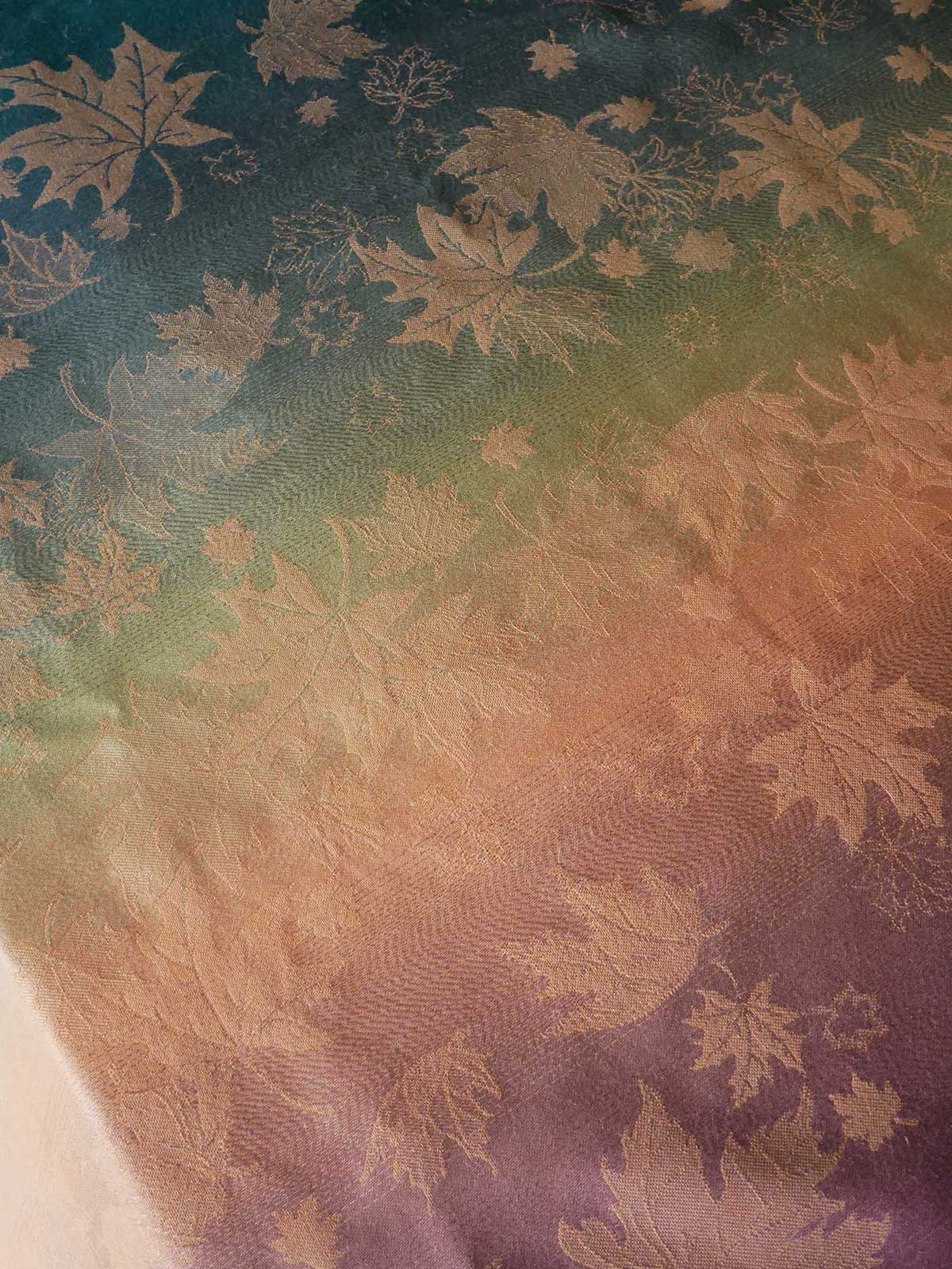 Textile with leaf pattern on a gradient background. 