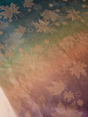 Textile with leaf pattern on a gradient background. 