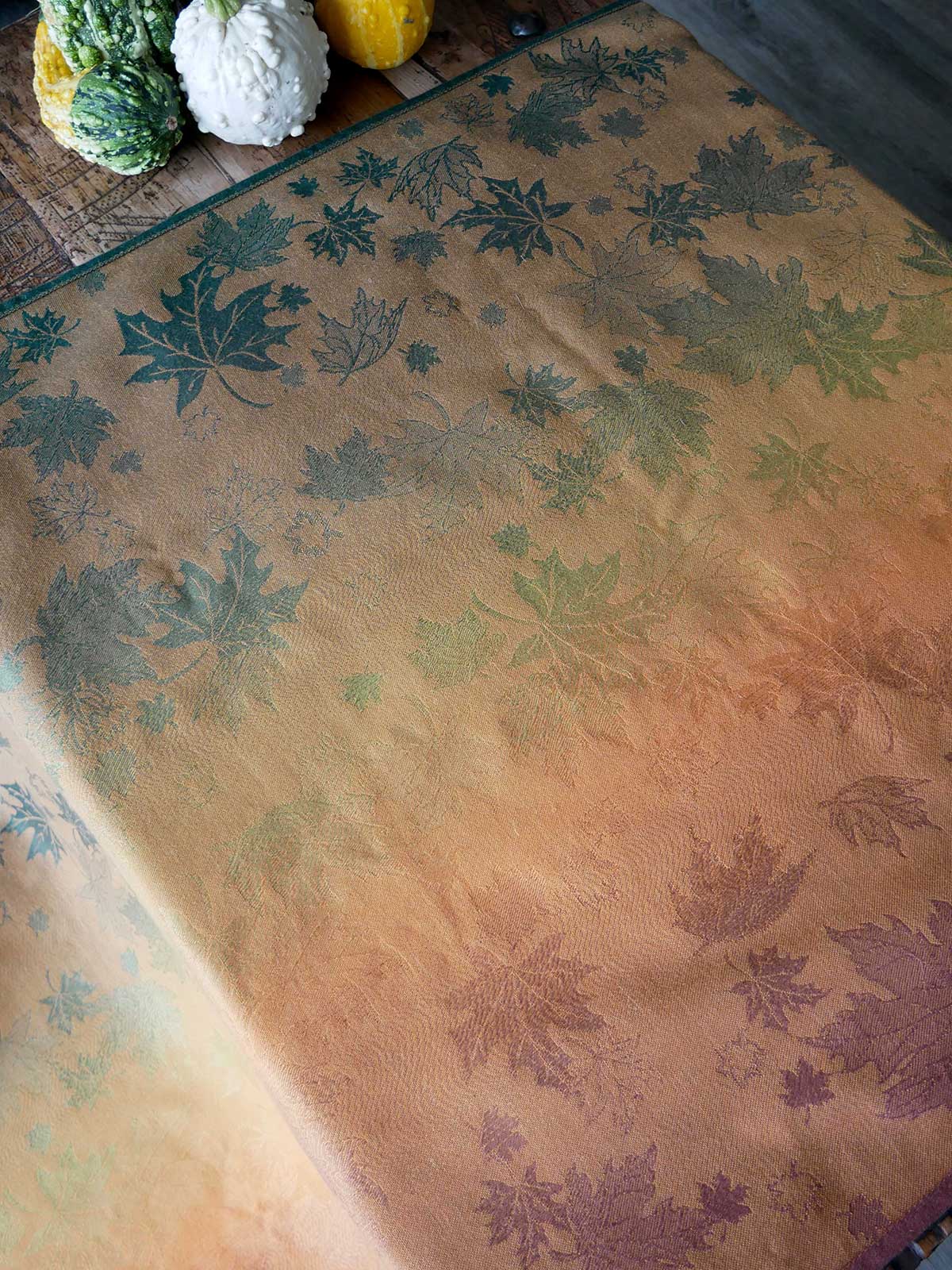 Reverse side of textile with leaf pattern on a wooden surface