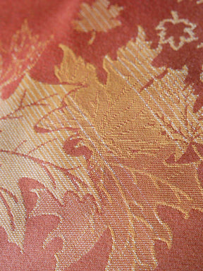 Close up of a orange fabric with leaf pattern