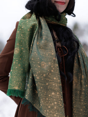Person wearing a green patterned scarf with a blurred background