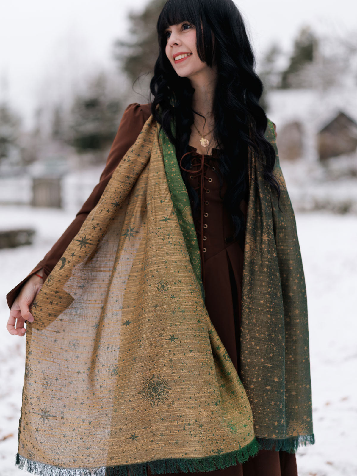Woman wearing a large patterned scarf outdoors in a snowy setting