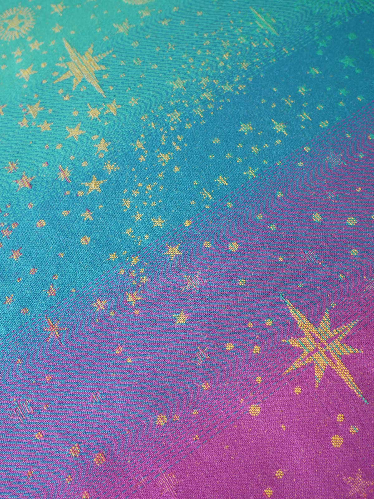 Colorful fabric with star pattern transitioning from blue to purple