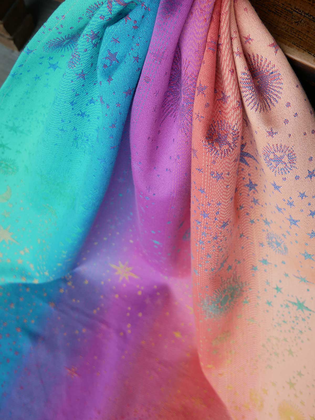 Colorful fabric with star patterns in shades of blue, pink, and orange.