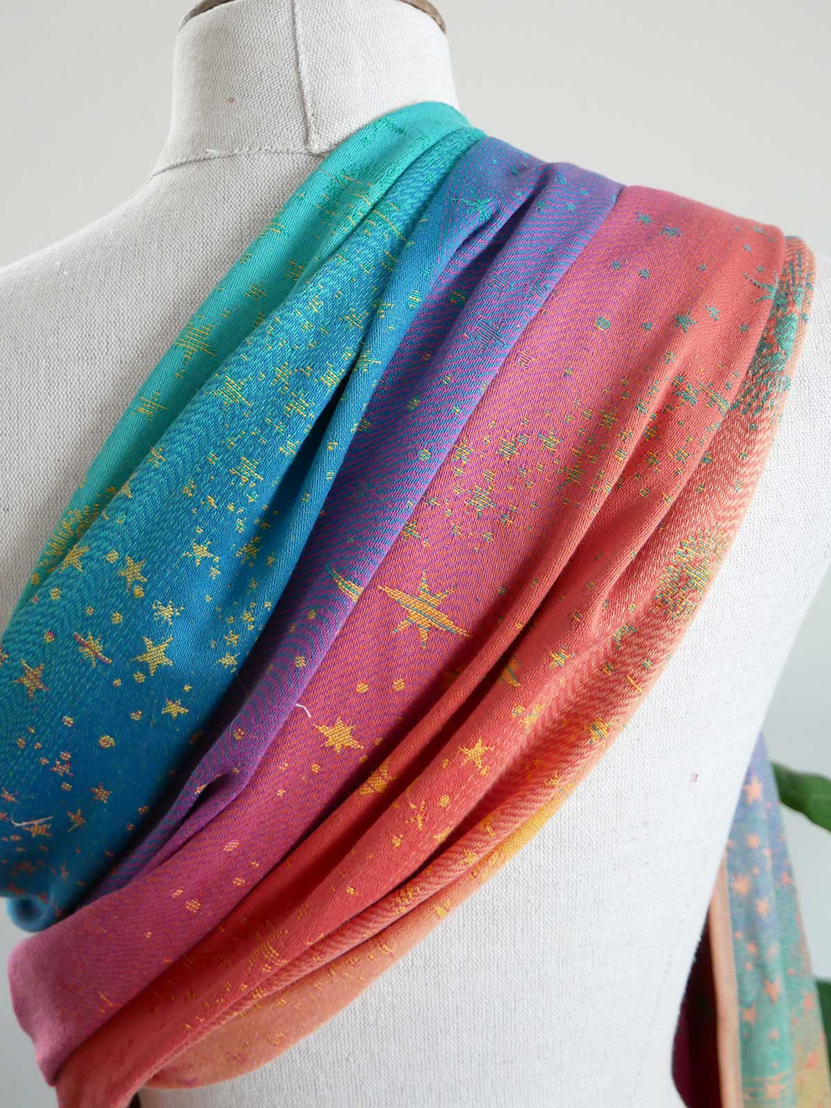 Colorful fabric with star patterns draped over a mannequin.