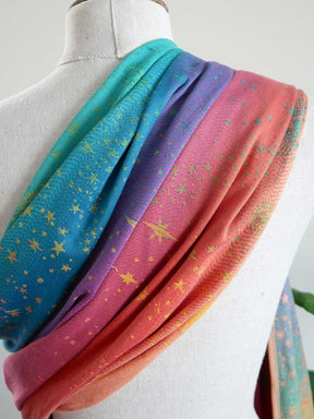 Colorful fabric with star patterns draped over a mannequin.
