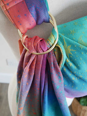 Close-up of colorful ring sling with a gold ring,