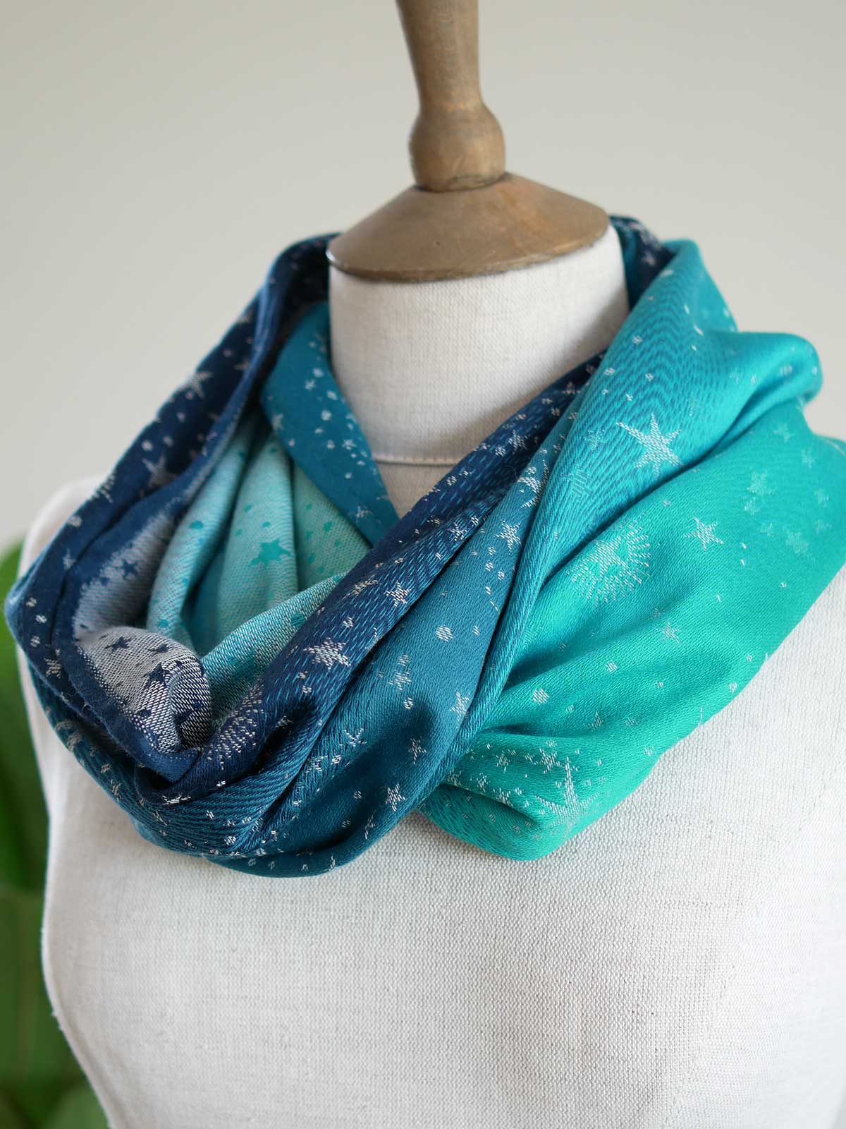 Blue and teal cowl with starry pattern on a mannequin