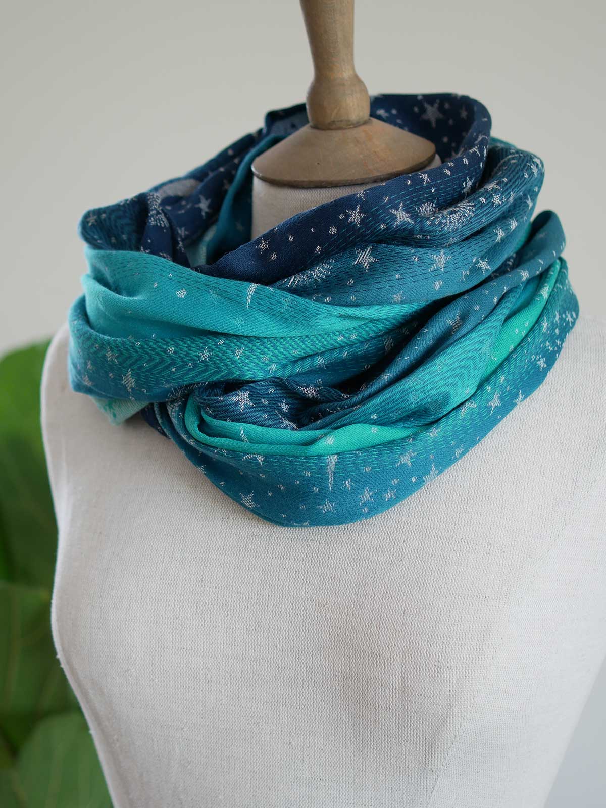 Blue and teal infinity loop with starry pattern looped twice on a mannequin