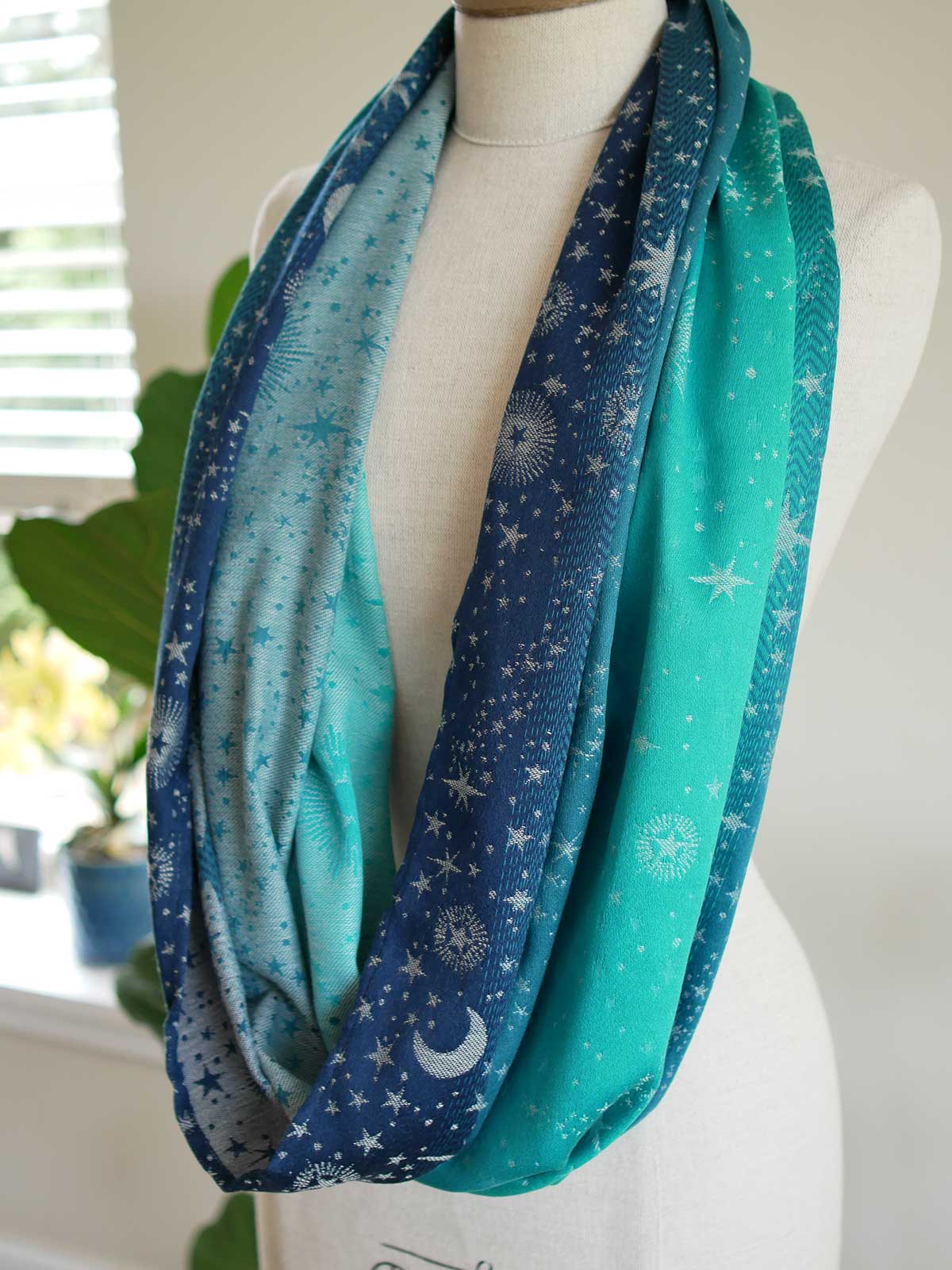 Blue and teal loop with starry pattern draped over a mannequin