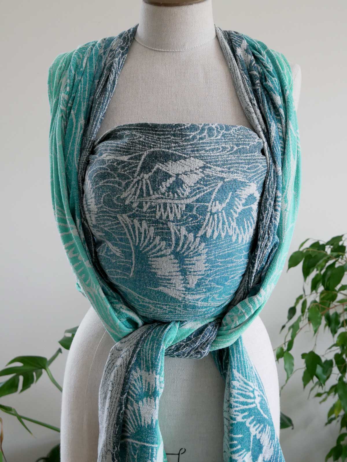 Mannequin wearing a turquoise and white Cranes Pointbreak Baby Wrap 