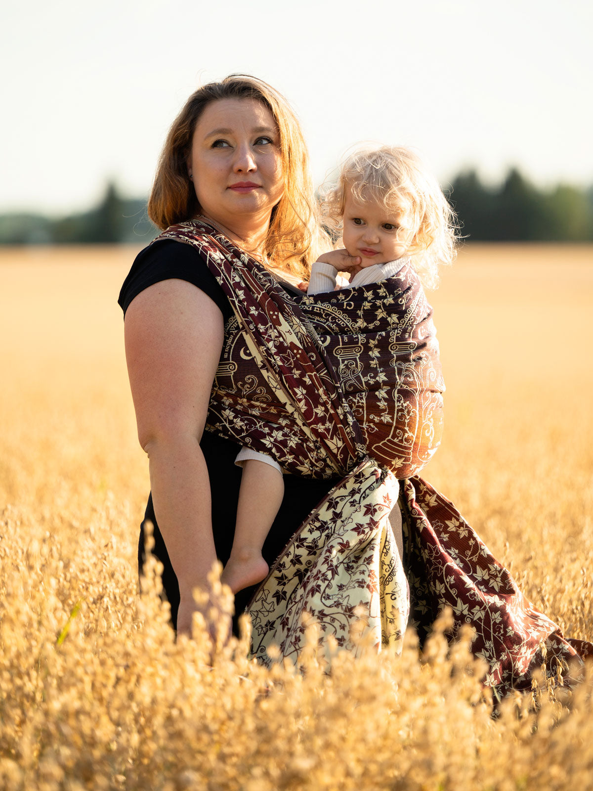 Woman holding a child in a field using Doors of Durin Ornament Baby Wrap