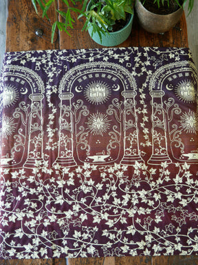 Woven fabric with in autumnal colours on a wooden surface