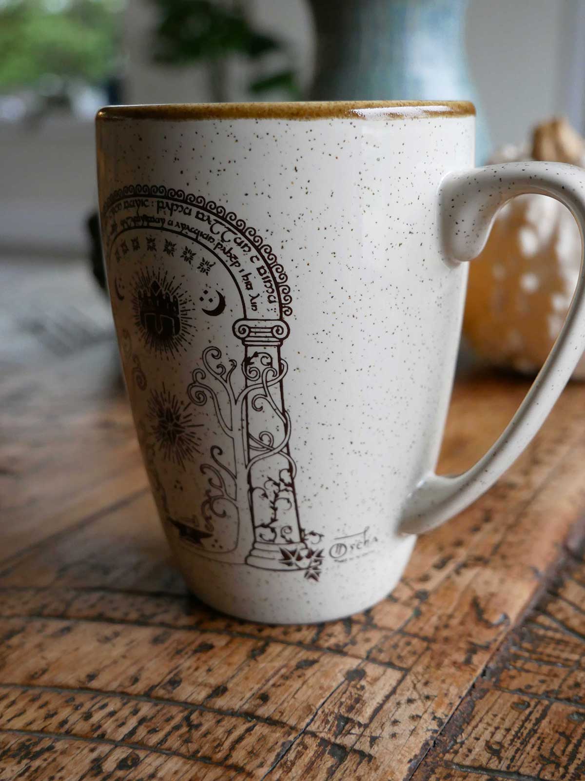 Ceramic mug with decorative design on a wooden surface