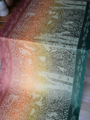 Textile with leaf pattern on a wooden surface