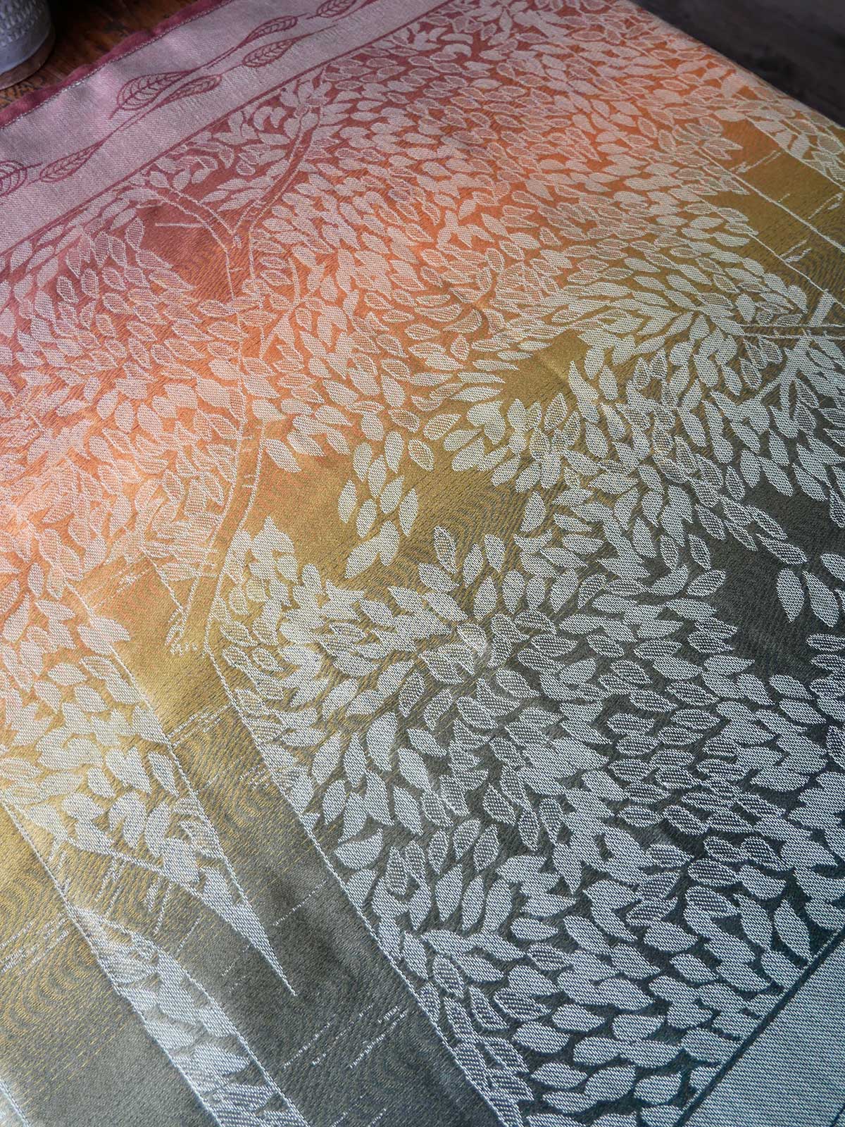 Textile with leaf pattern and gradient colors on a flat surface