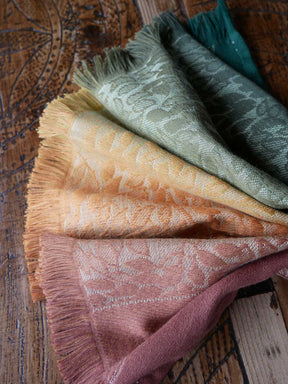 Folded scarf in various colors on a wooden surface