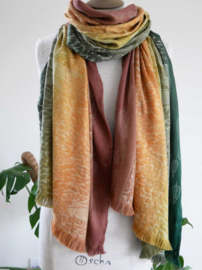 Multicolored scarf draped over a mannequin with a white background