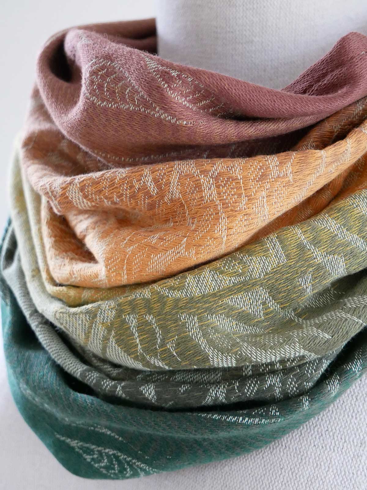 Patterned scarf in various colors on a white background