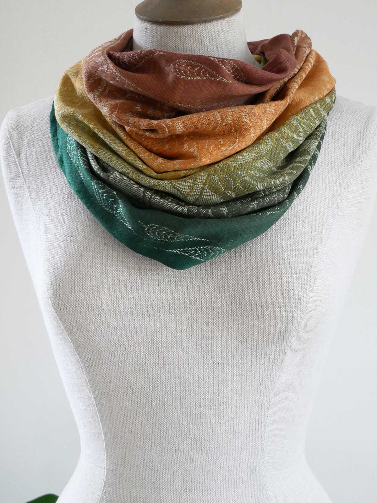 Autumnal scarf on a mannequin against a white background