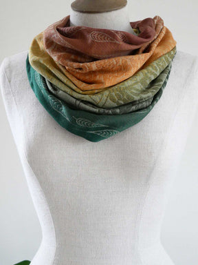 Autumnal scarf on a mannequin against a white background