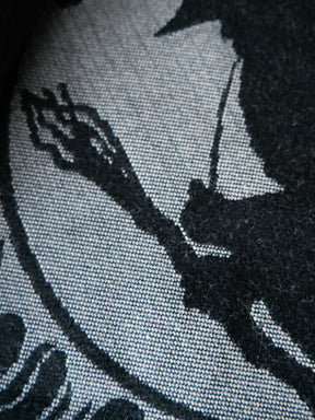 Black and silver patterned fabric with a central design