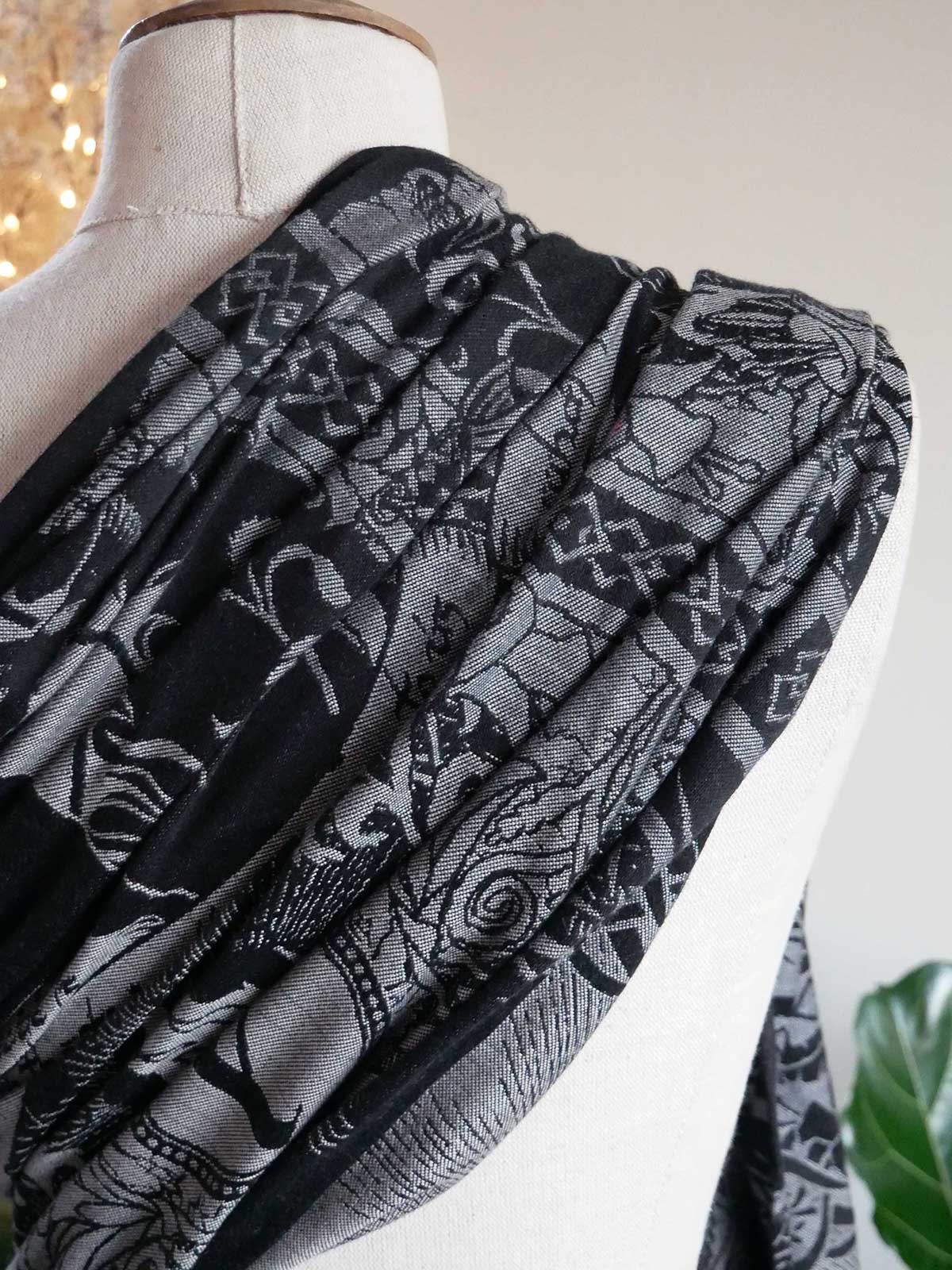 Black and gray patterned fabric draped over a mannequin