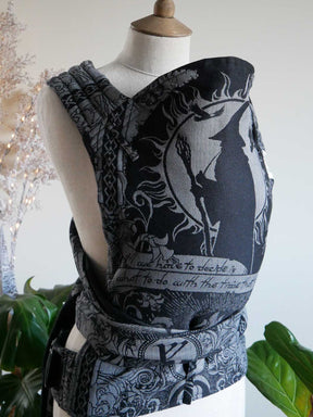 Black and silver patterned carrier on a mannequin with a decorative background