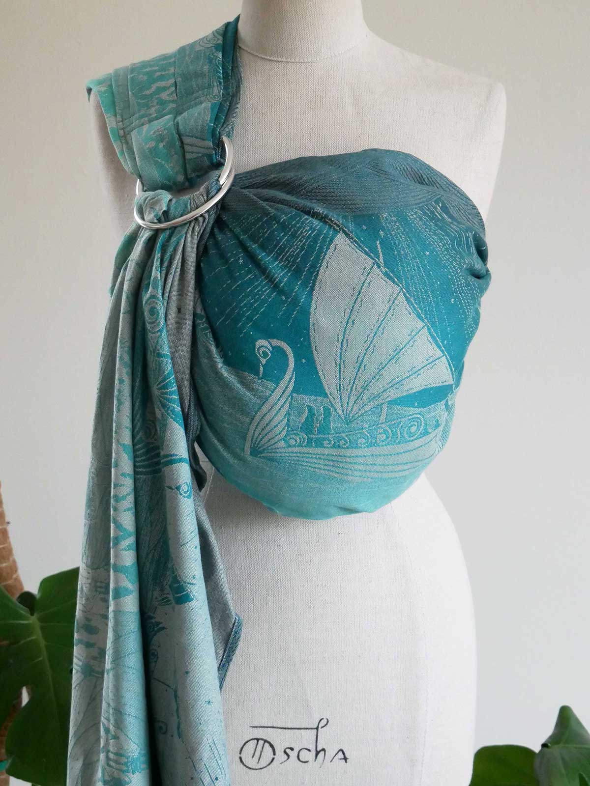 Teal Grey Havens into the West Ring Sling on a mannequin with a white background