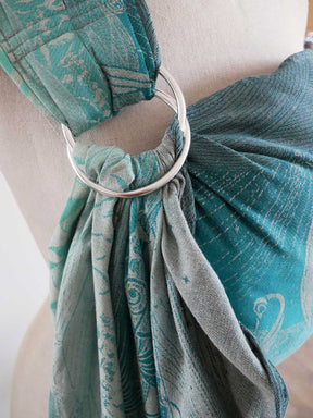 Teal sling with a silver ring on a mannequin