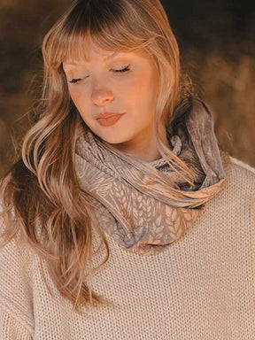 Woman wearing an oatmeal coloured scarf