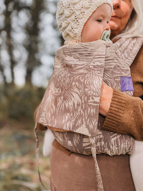 Baby in a patterened baby carrier.