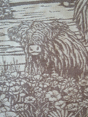 Close-up of a fabric with a pattern of a cow and landscape