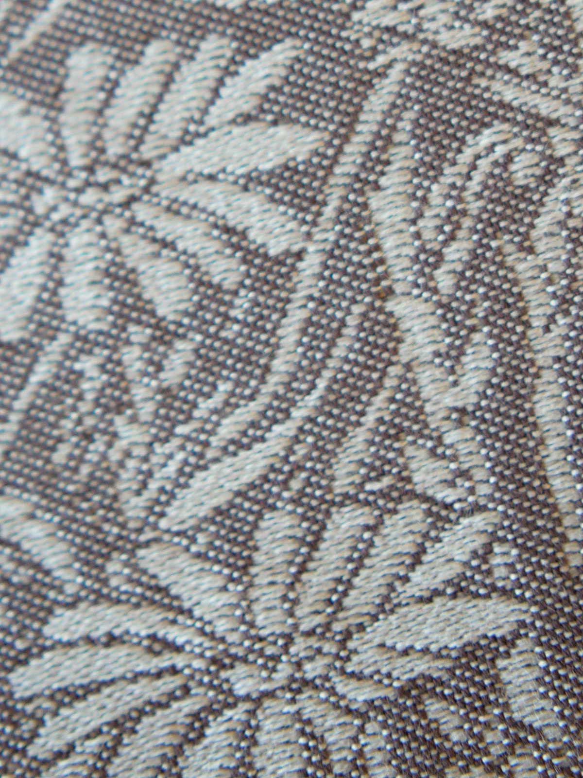 Close-up of a textured fabric with leaf pattern