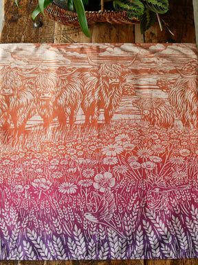 Flat lay of a colourful fabric with Highland cow pattern