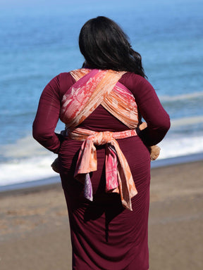 Back view of baby wrap tied round model. 