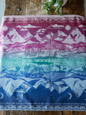 Colourful fabric with mountain and landscape patterns on a wooden surface