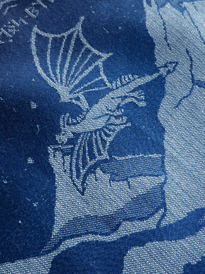 Textile pattern with dragon design on a blue background
