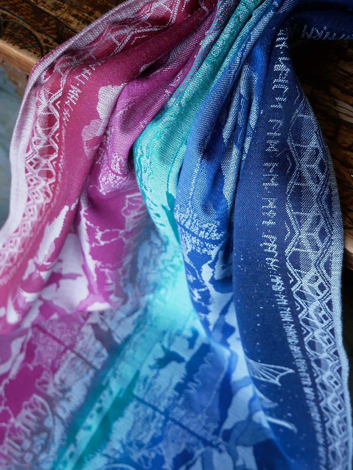 Close-up of colorful fabric with patterns, including pink, blue, and green.