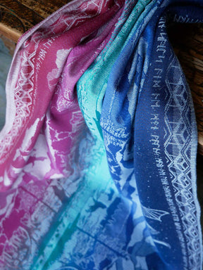 Close-up of colorful fabric with patterns, including pink, blue, and green.