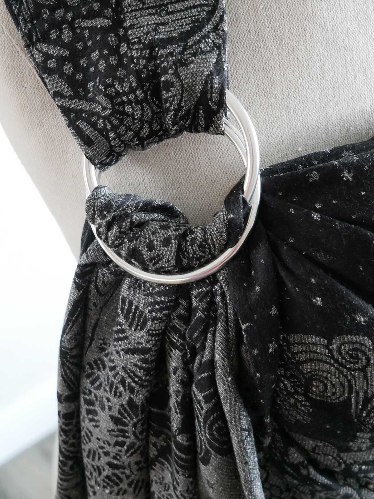 Close up of a silver ring on a black ring sling