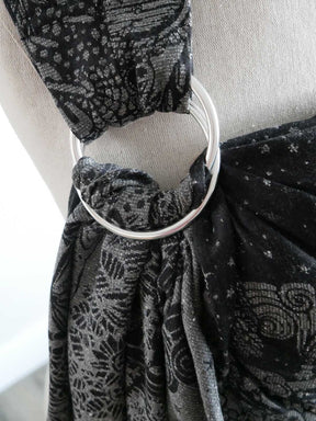 Close up of a silver ring on a black ring sling